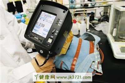 实验人员用逆反射系数检测仪检测书包的逆反射系数。